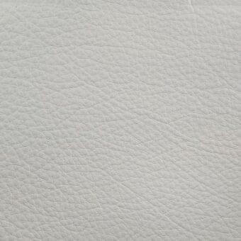 Light gray pebble-grain leather texture sample on white, displaying a dense, irregular pattern and matte crema finish, labeled “erba crystal.”